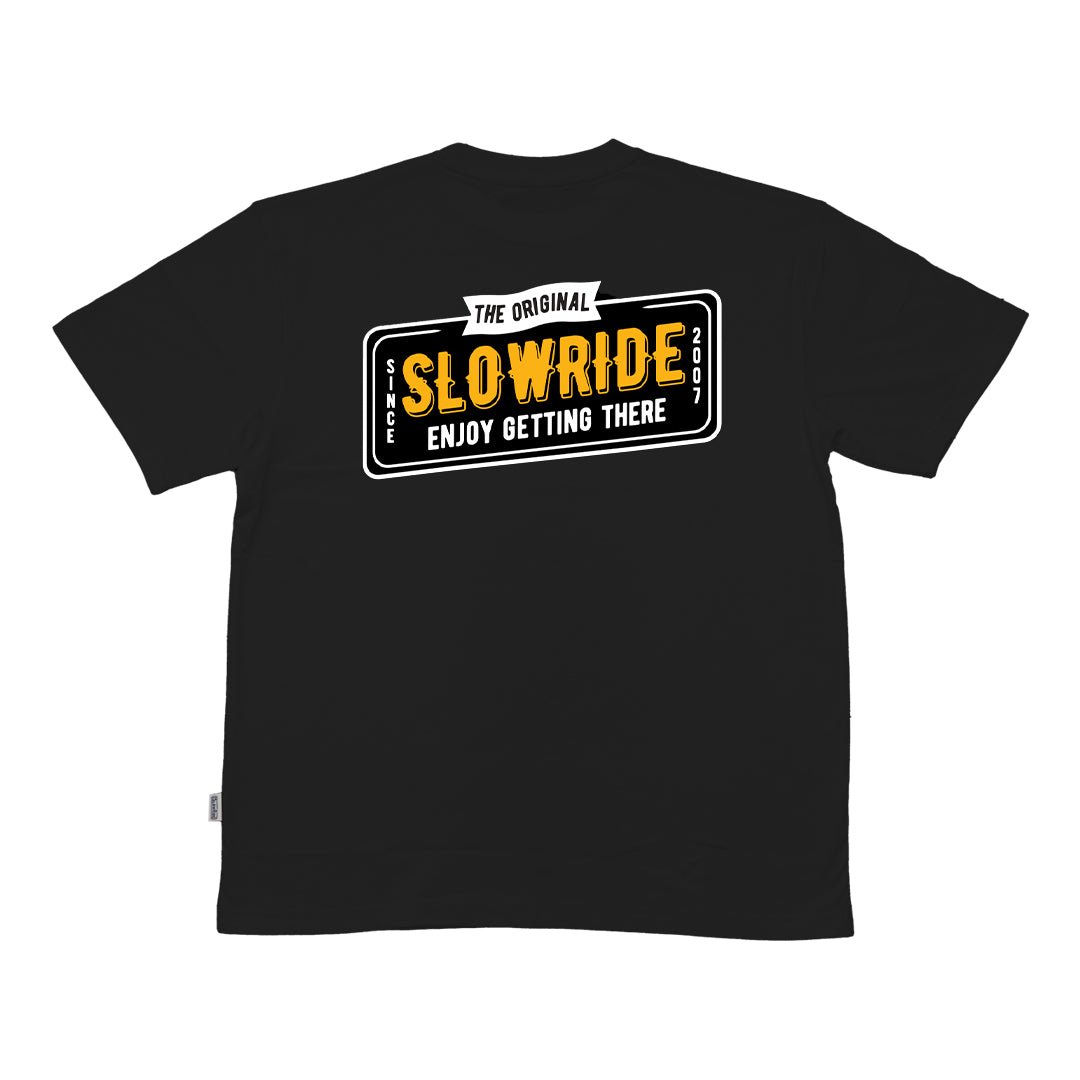 License Plate Heavyweight Tee (Black)- Slow Ride- Classic Slow Ride t-shirt available in black and white, featuring a vintage-inspired license plate graphic with 'The Original Slow Ride' and 'Enjoy Getting There' text. Perfect for fans of Off-Roading, Off-Road Racing, and the vintage Volkswagen culture, including the iconic Volkswagen bus, Volkswagen bug, and Baja bug. This slow ride shirt embodies the spirit of Garage and Racing, making it ideal for blue-collar workwear enthusiasts who live by mottos like