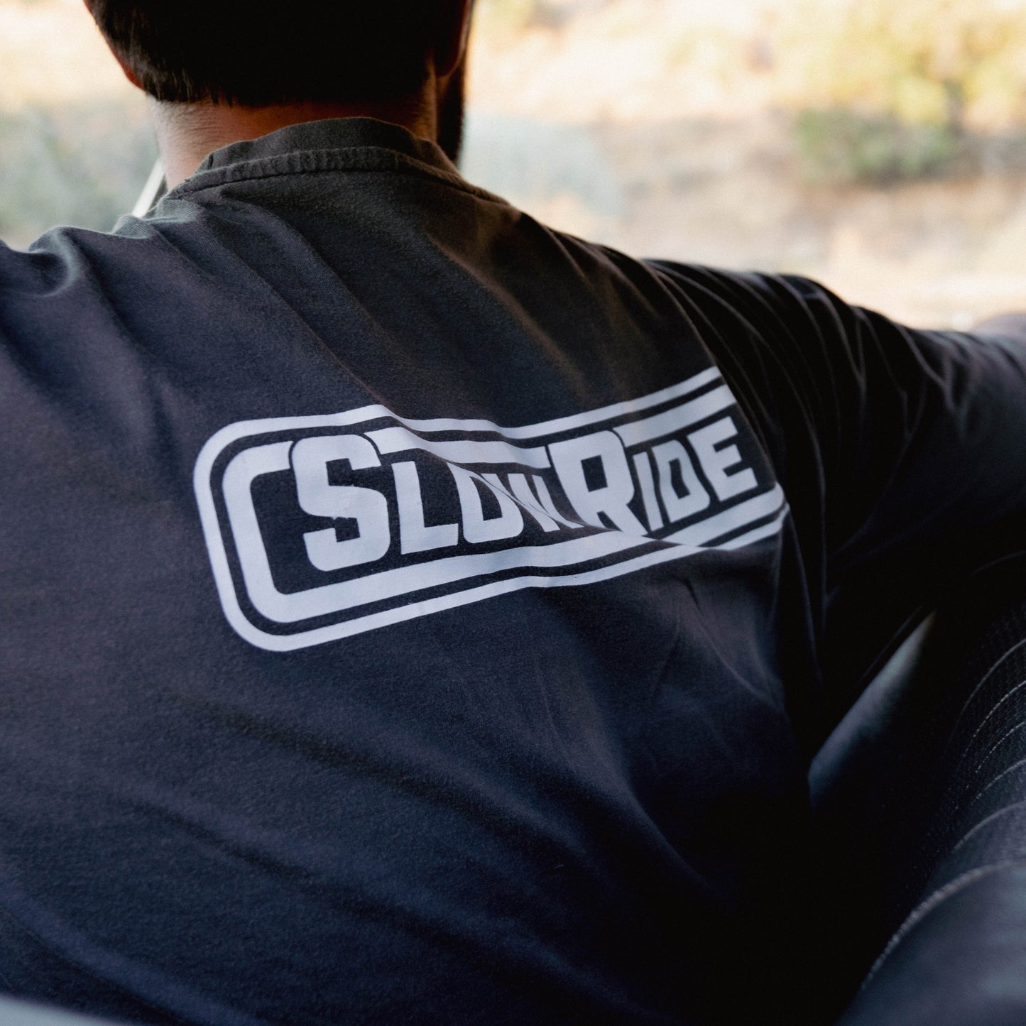 Radio Heavyweight Tee (Vintage Black) - Slow Ride- Essential Slow Ride t-shirt available in black and vintage black, featuring the iconic 'Slow Ride' logo on the back. Ideal for fans of Off-Roading and Off-Road Racing, this slow ride shirt celebrates the vintage Volkswagen culture, including the Volkswagen bus, Volkswagen bug, and Baja bug. Perfect for those who embrace the Garage and Racing lifestyle and live by mottos like 'Enjoy Getting There,' 'Wheelin and Spilling,' and 'Restore and Destroy.' A must-ha