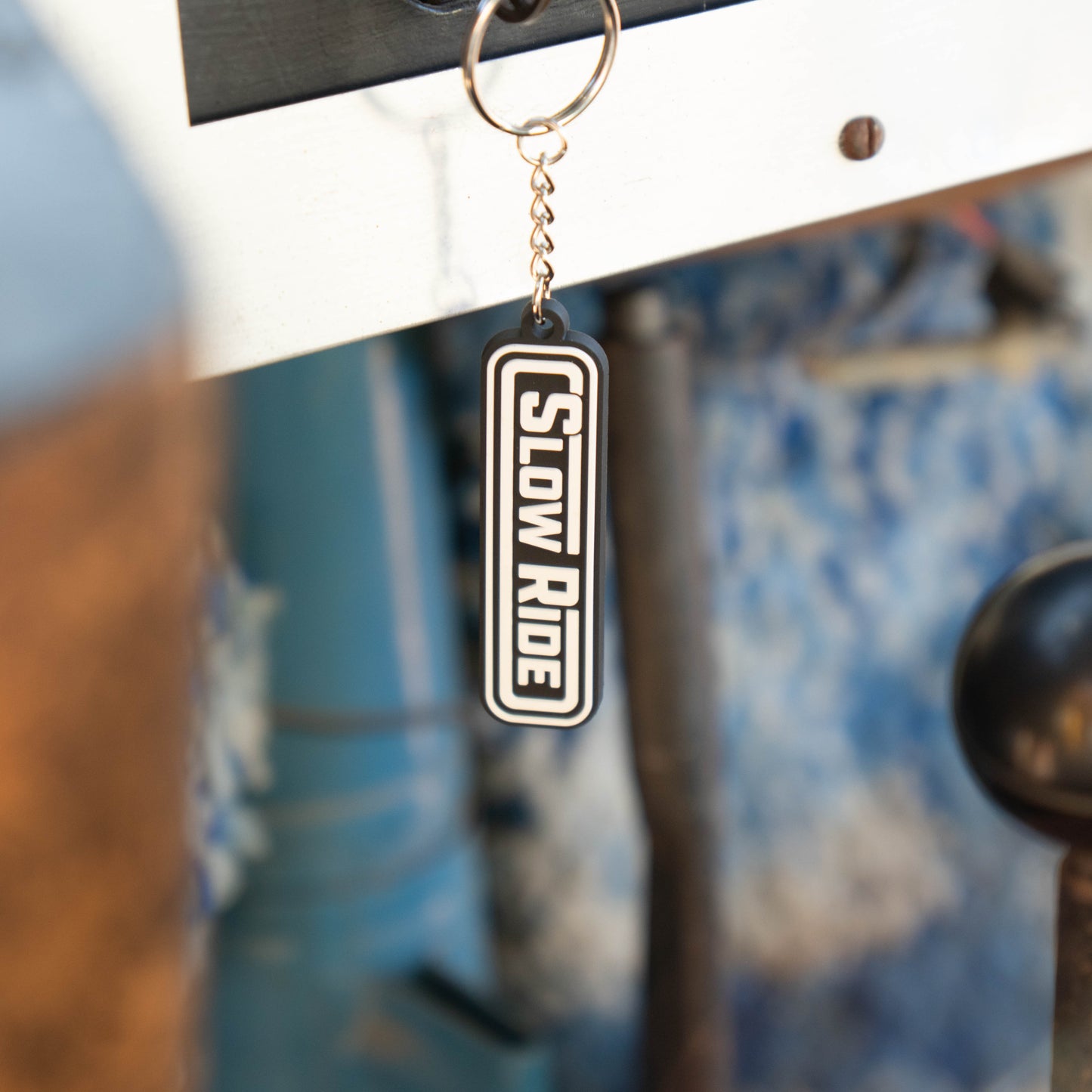 Radio Keychain - Slow Ride- Classic Slow Ride keychain featuring the iconic 'Slow Ride' logo in black and white, perfect for fans of Off-Roading and Off-Road Racing. This keychain is an ideal accessory for vintage Volkswagen enthusiasts, including those who love the Volkswagen bus, Volkswagen bug, and Baja bug. A great addition to any Garage and Racing lifestyle, this keychain embodies the spirit of Slow Ride Garage and mottos like 'Enjoy Getting There,' 'Wheelin and Spilling,' and 'Restore and Destroy.' A
